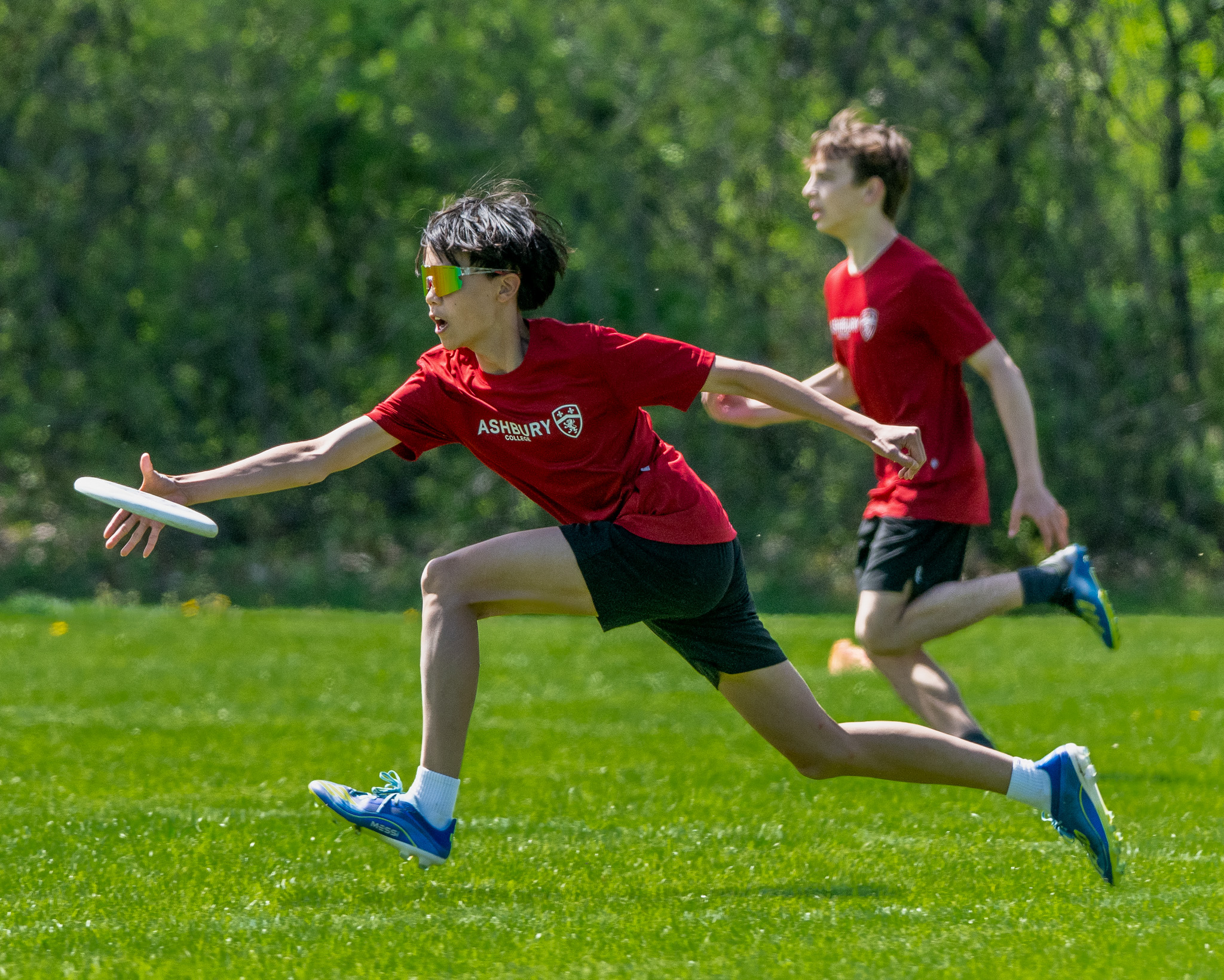 Young man reaching to grab a frisbee